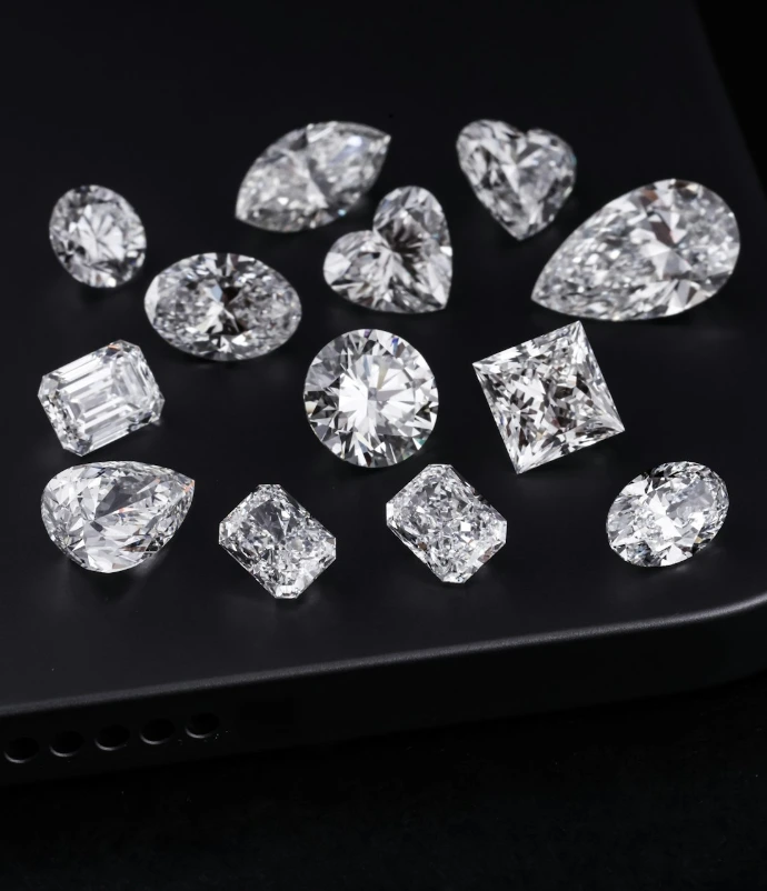 Diamonds of various shapes are on a black surface